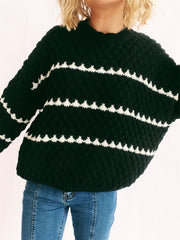 Black textured knit jumper with white chevron stripes and a crew neck.