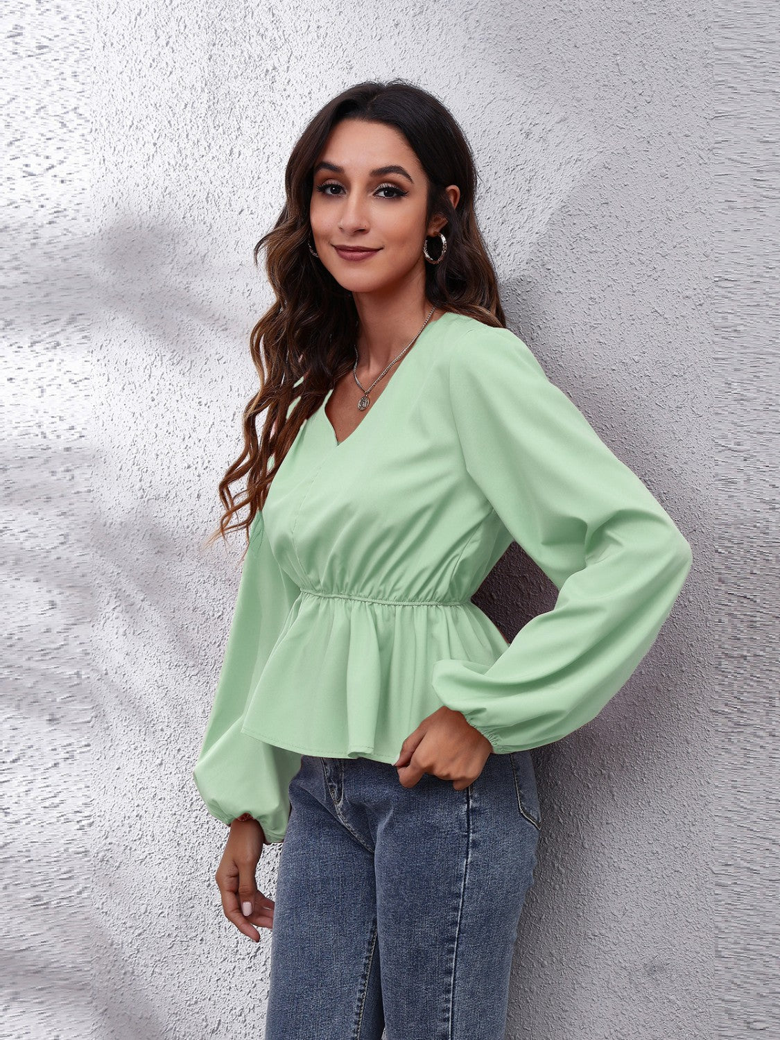 Light green peplum blouse with V-neck and balloon sleeves
