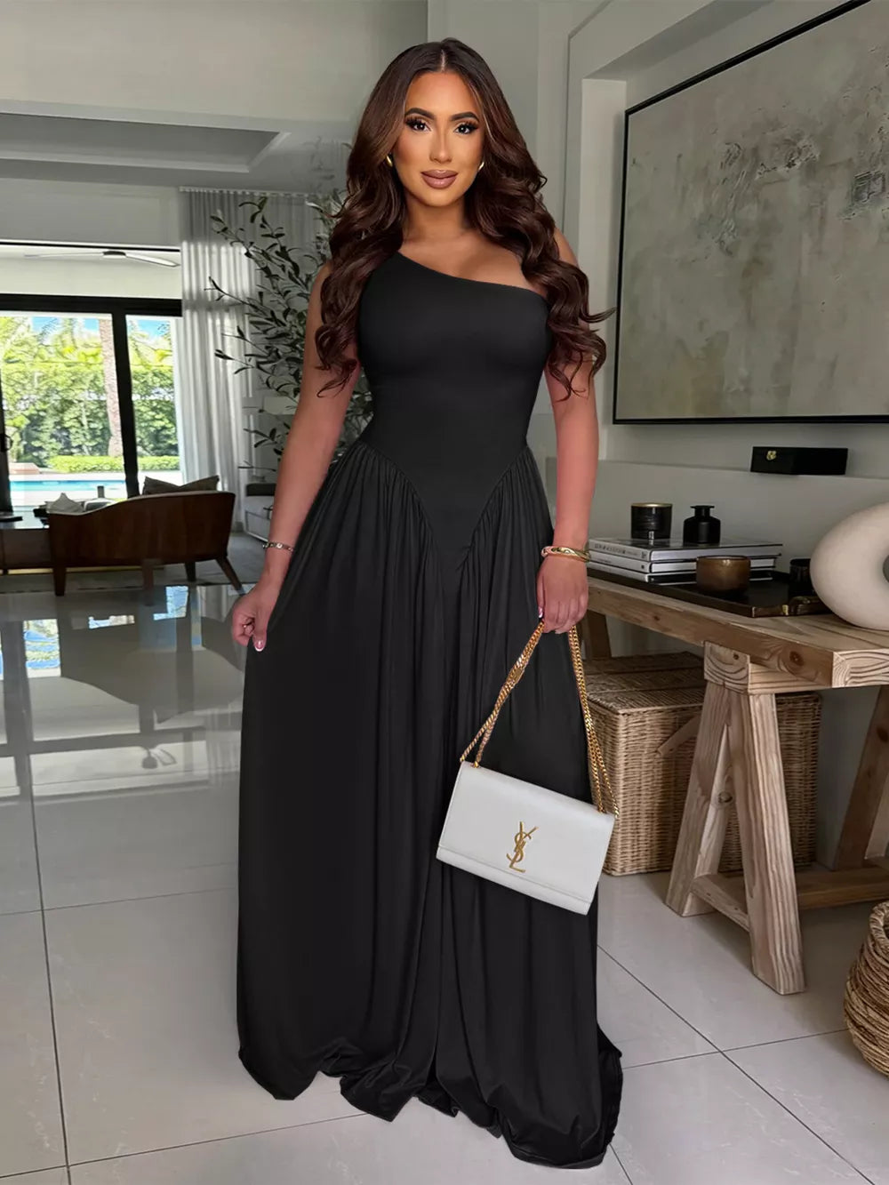 Black ruched one-shoulder evening dress with flowing skirt.