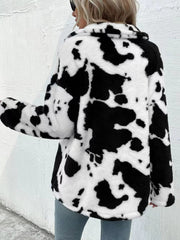 Cow print plush shacket in white and black with a collar and button front.