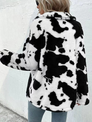 Cow print plush shacket in white and black with a collar and button front.
