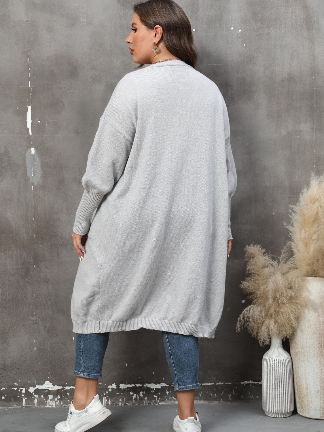 Oversized light gray knit duster cardigan with long sleeves and ribbed cuffs.
