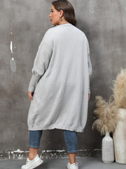 Oversized light gray knit duster cardigan with long sleeves and ribbed cuffs.