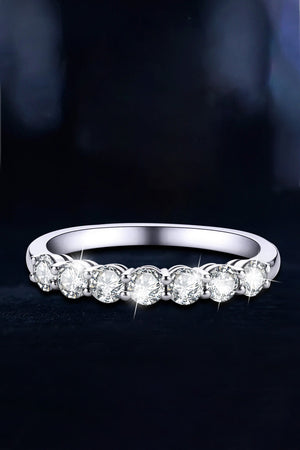Silver band ring with seven round-cut moissanite stones.