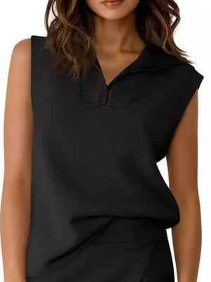 Black sleeveless quarter-zip top with a collared neckline and asymmetrical skort.