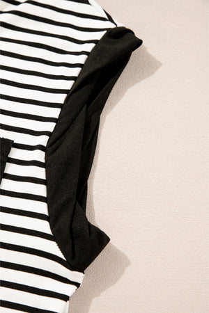 Black and white striped t-shirt with black sleeves and a pocket detail.