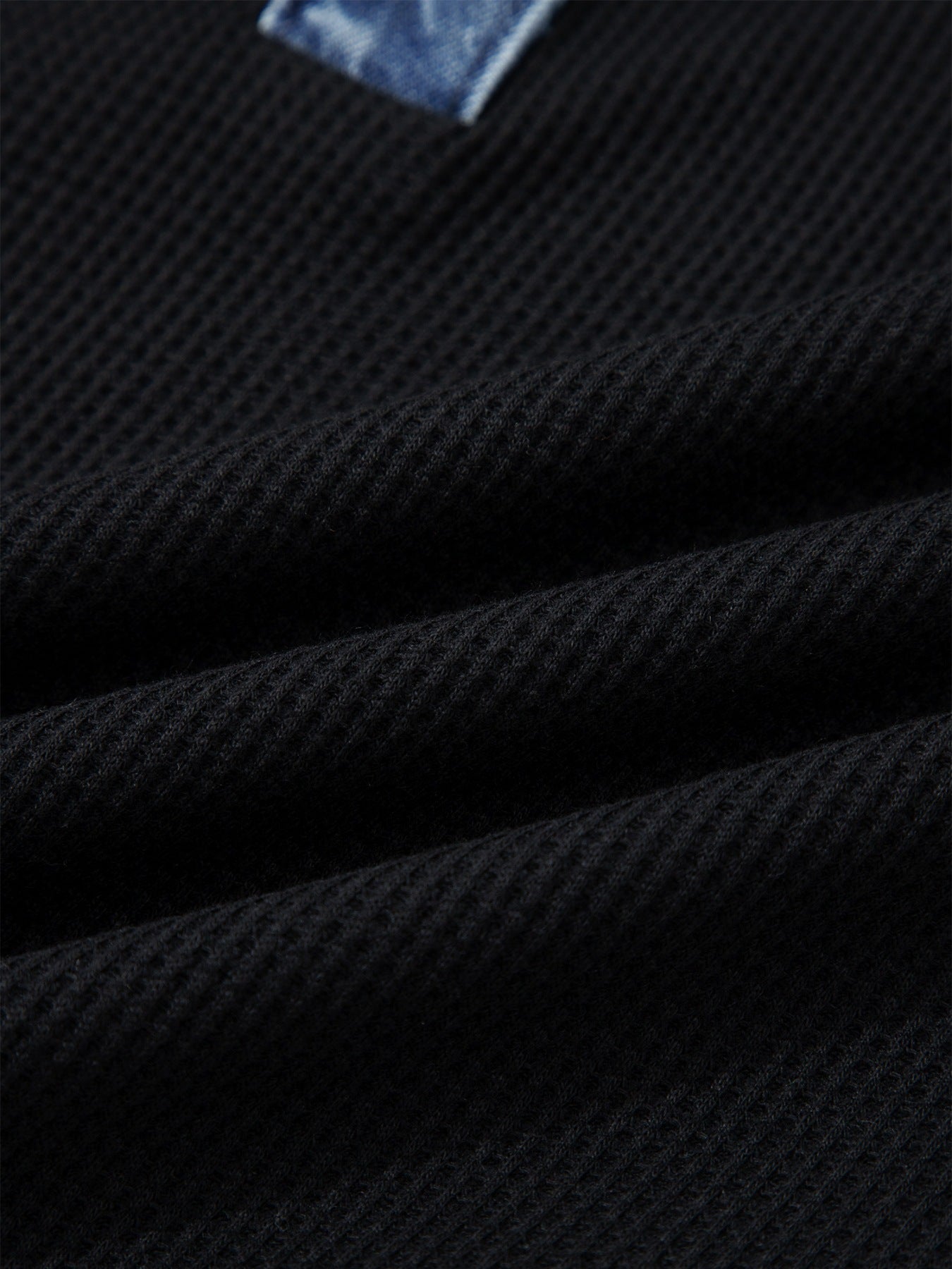 Black textured knit polo top with denim trim detail