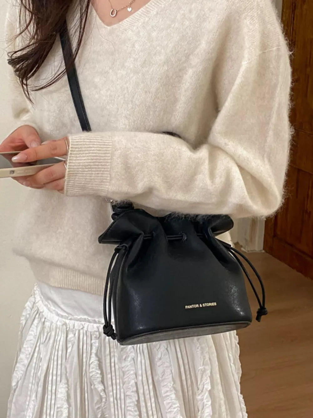 Drawstring Bucket Crossbody Bag in Black, close-up detail