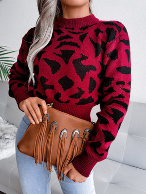Crimson abstract knit cropped sweater with mock neck and long sleeves.