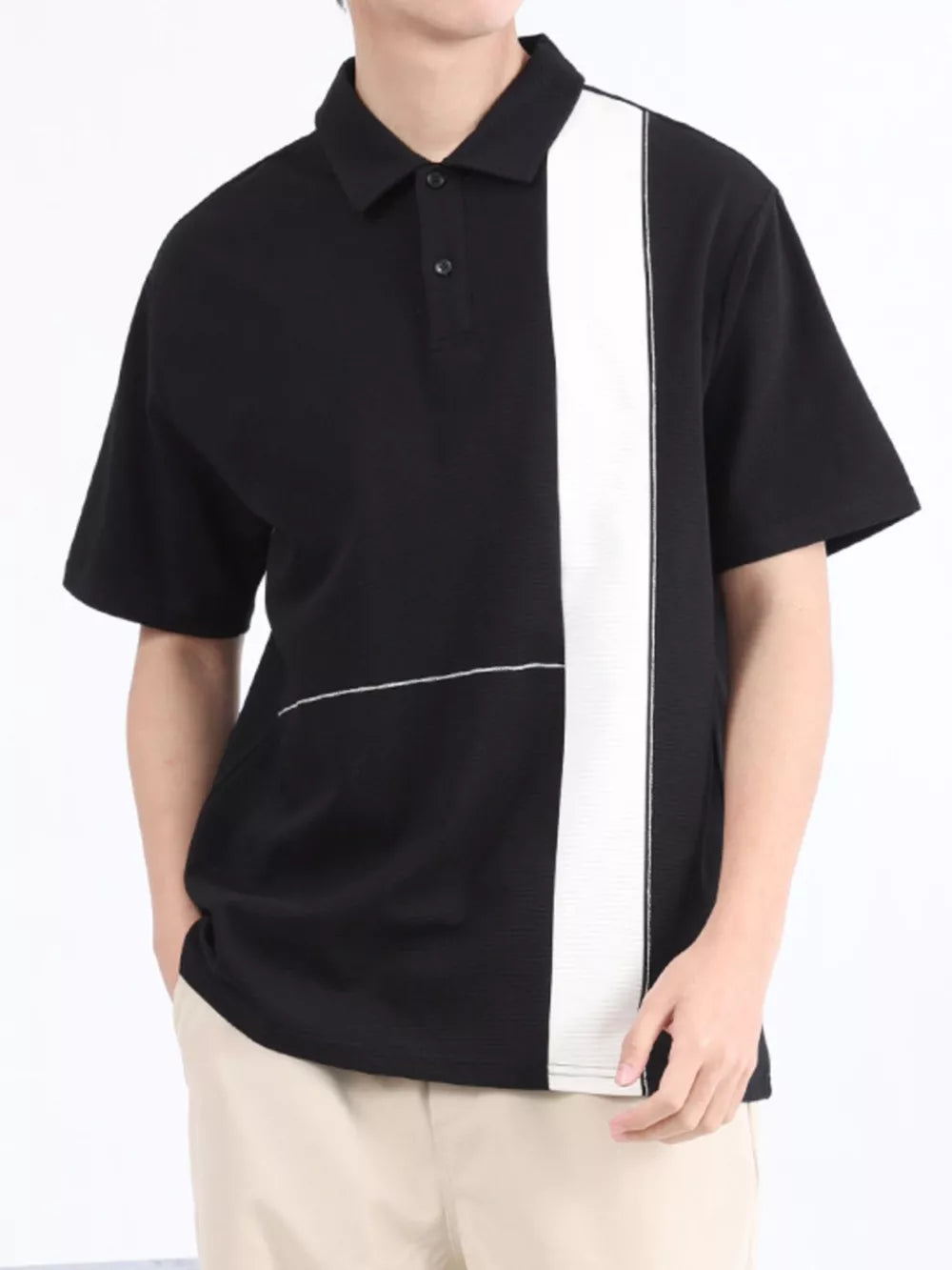 Black and white color block polo shirt with short sleeves and a two-button placket.