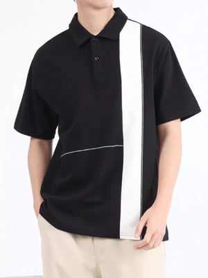 Black and white color block polo shirt with short sleeves and a two-button placket.