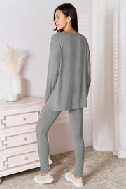 Gray knit loungewear set with V-neck top and leggings.