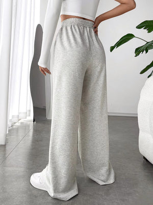 Light gray sweatpants with V-waistline and center seams, wide leg palazzo cut.