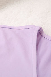 Draped wrap top detail in soft lilac purple fabric with clean stitching.