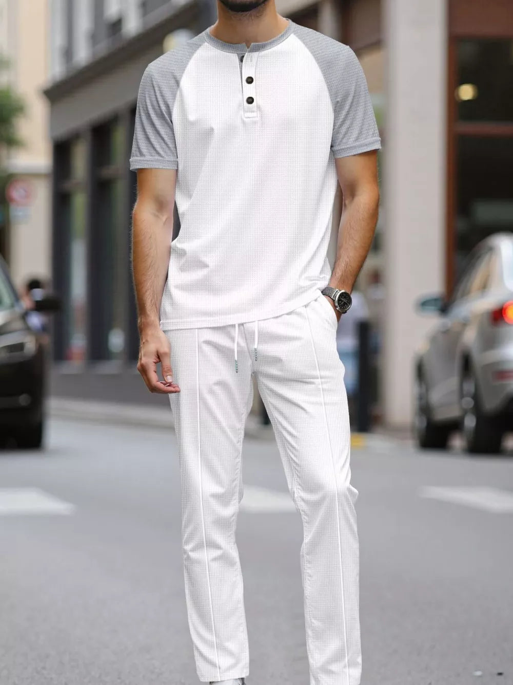 Men's white henley loungewear set with grey raglan sleeves and drawstring pants.