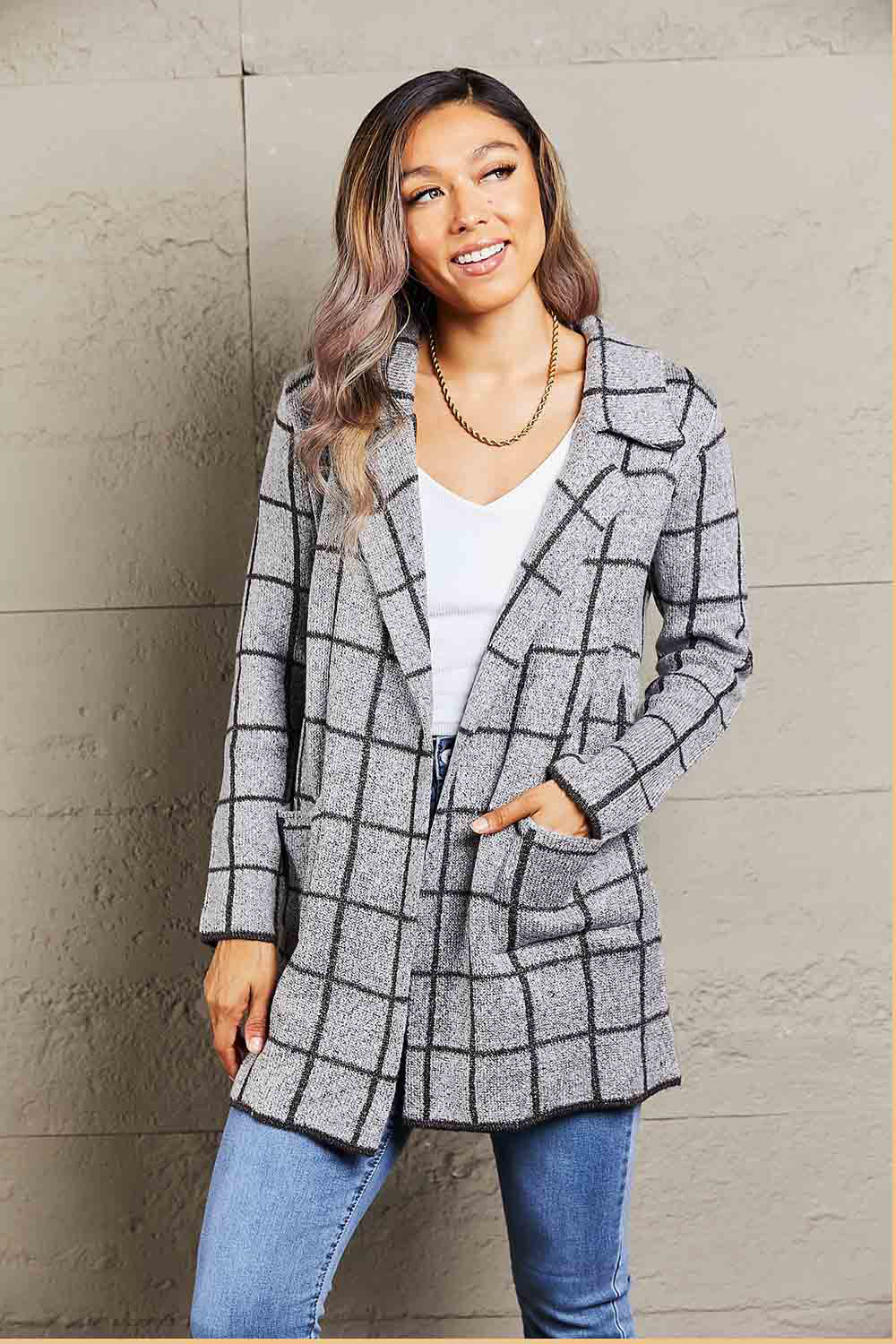 Gray grid-print knit blazer coat with pockets and lapels, styled open over a white top.