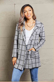 Gray grid-print knit blazer coat with pockets and lapels, styled open over a white top.