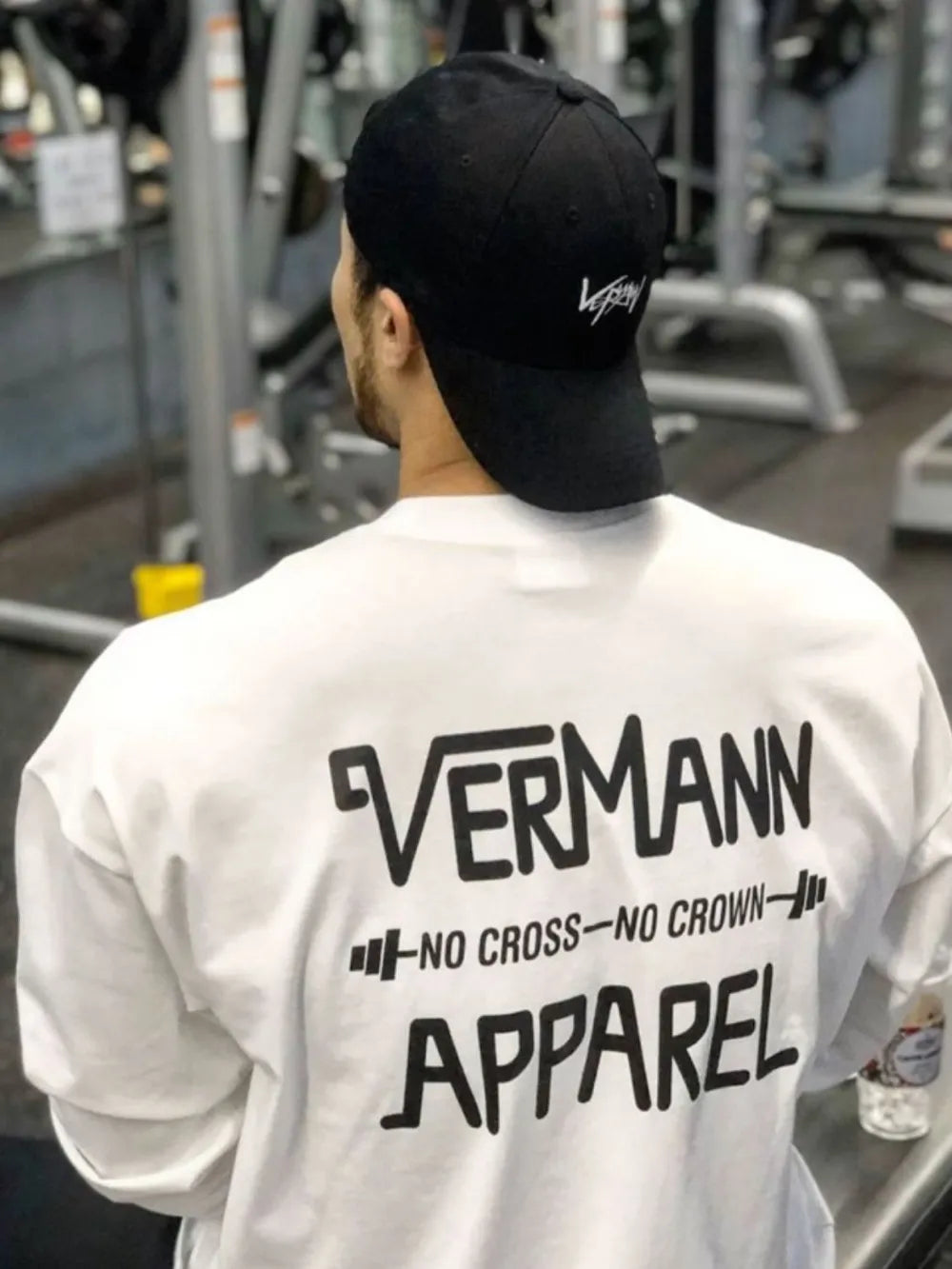 White oversized graphic tee with black Vermann Apparel logo and barbell design.