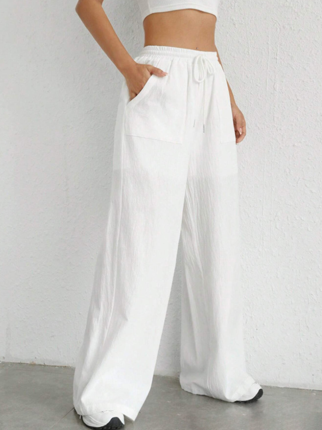 White linen wide-leg drawstring trousers with side pockets