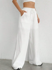 White linen wide-leg drawstring trousers with side pockets