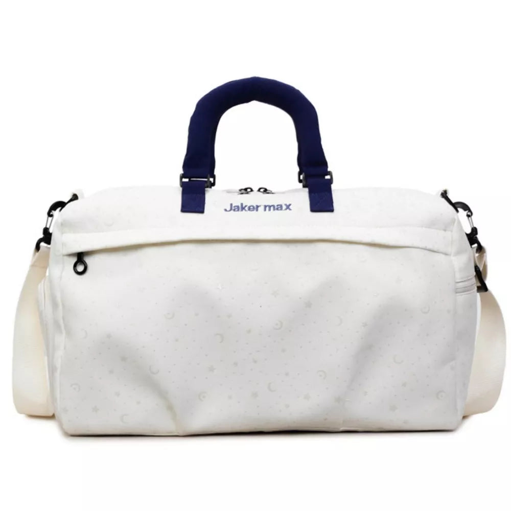 Cream white duffel bag with crescent moon and star pattern, navy handles and strap.