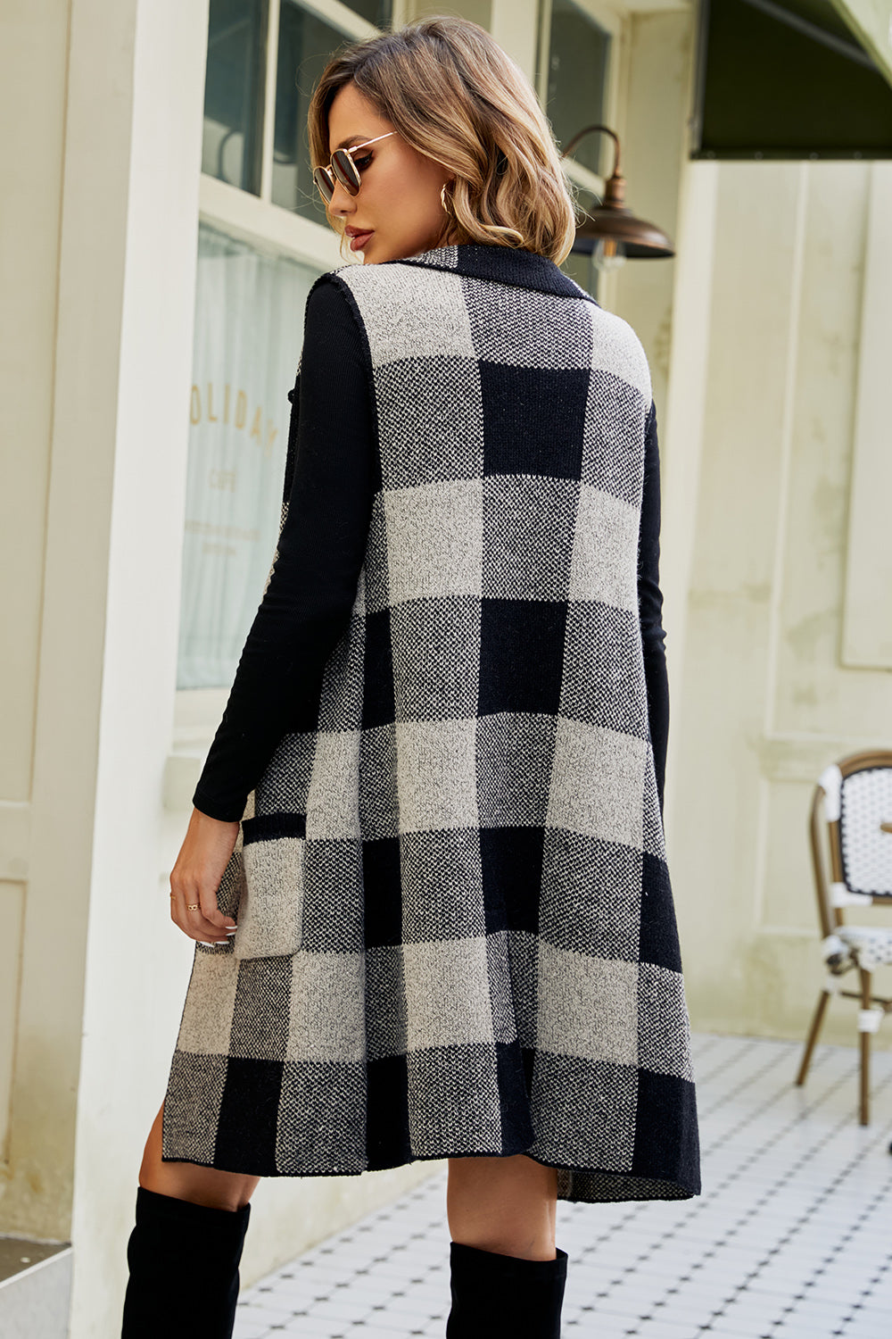 Longline checked plaid vest in black and tan acrylic, with a collared neckline and open front.