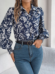 Navy floral print blouse with shirred cuffs and buttoned front.