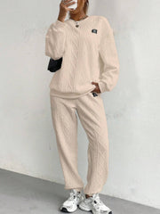 Tan cable knit loungewear set with crewneck sweatshirt and jogger pants.