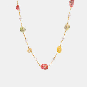 Gemstone Cascade Layered Necklace with colorful beads and pearls on a gold chain.