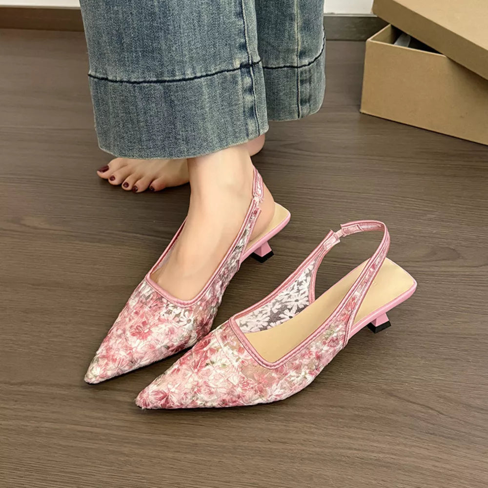 Pink lace slingback kitten heels with floral pattern and pointed toe.