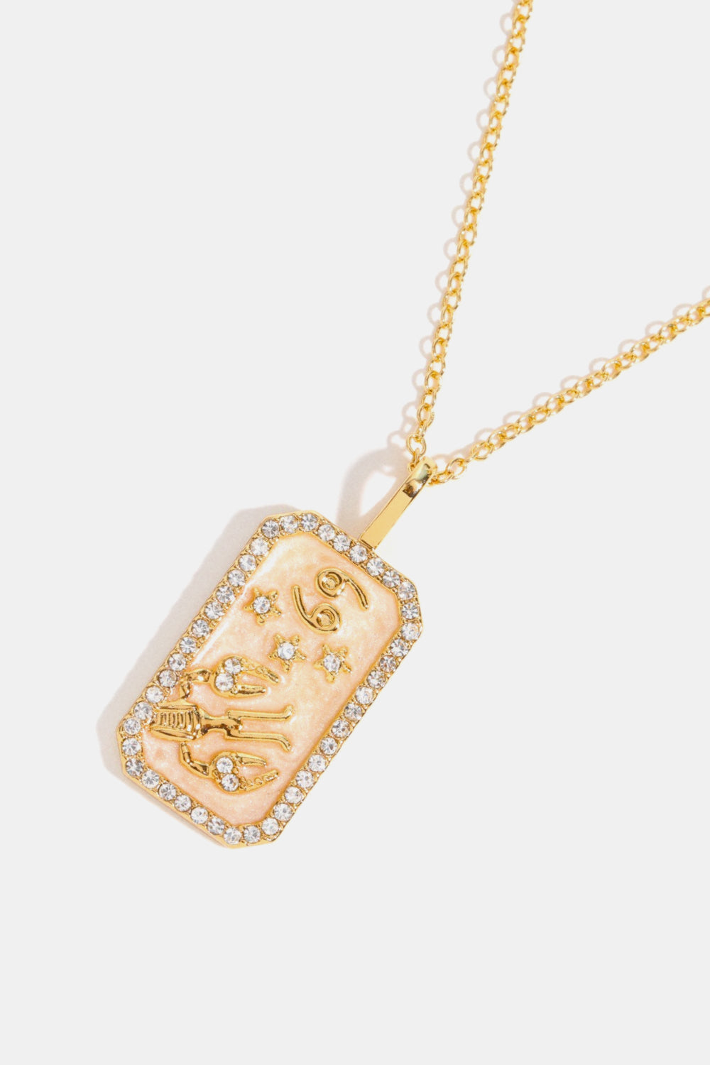 14K gold-plated Cancer zodiac sign crystal pendant necklace with a light pink enamel background.