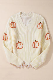 Beige distressed knit sweater with all-over pumpkin embroidery and frayed hem.