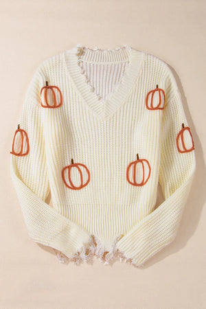 Beige distressed knit sweater with all-over pumpkin embroidery and frayed hem.