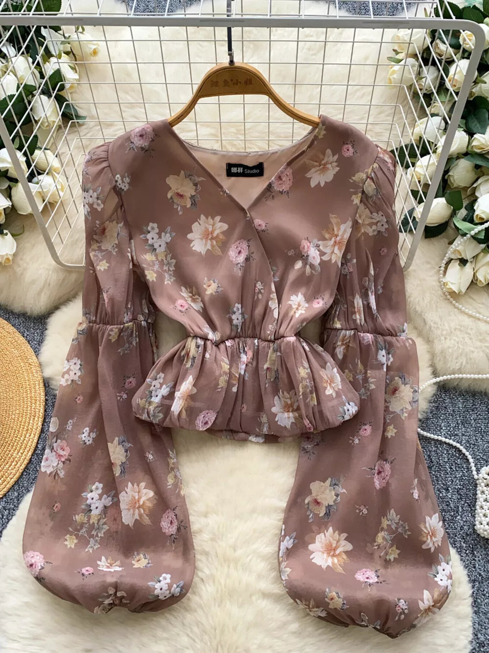 Brown floral chiffon blouse with V-neck, peplum hem and balloon sleeves.