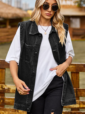Sleeveless dark gray denim utility vest with button front and chest pockets.