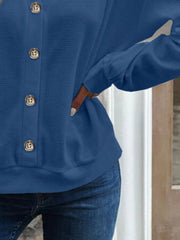 Blue waffle knit button-down cardigan with gold buttons.
