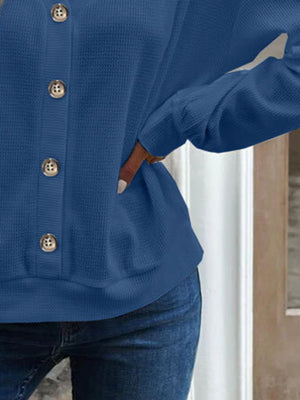 Blue waffle knit button-down cardigan with gold buttons.