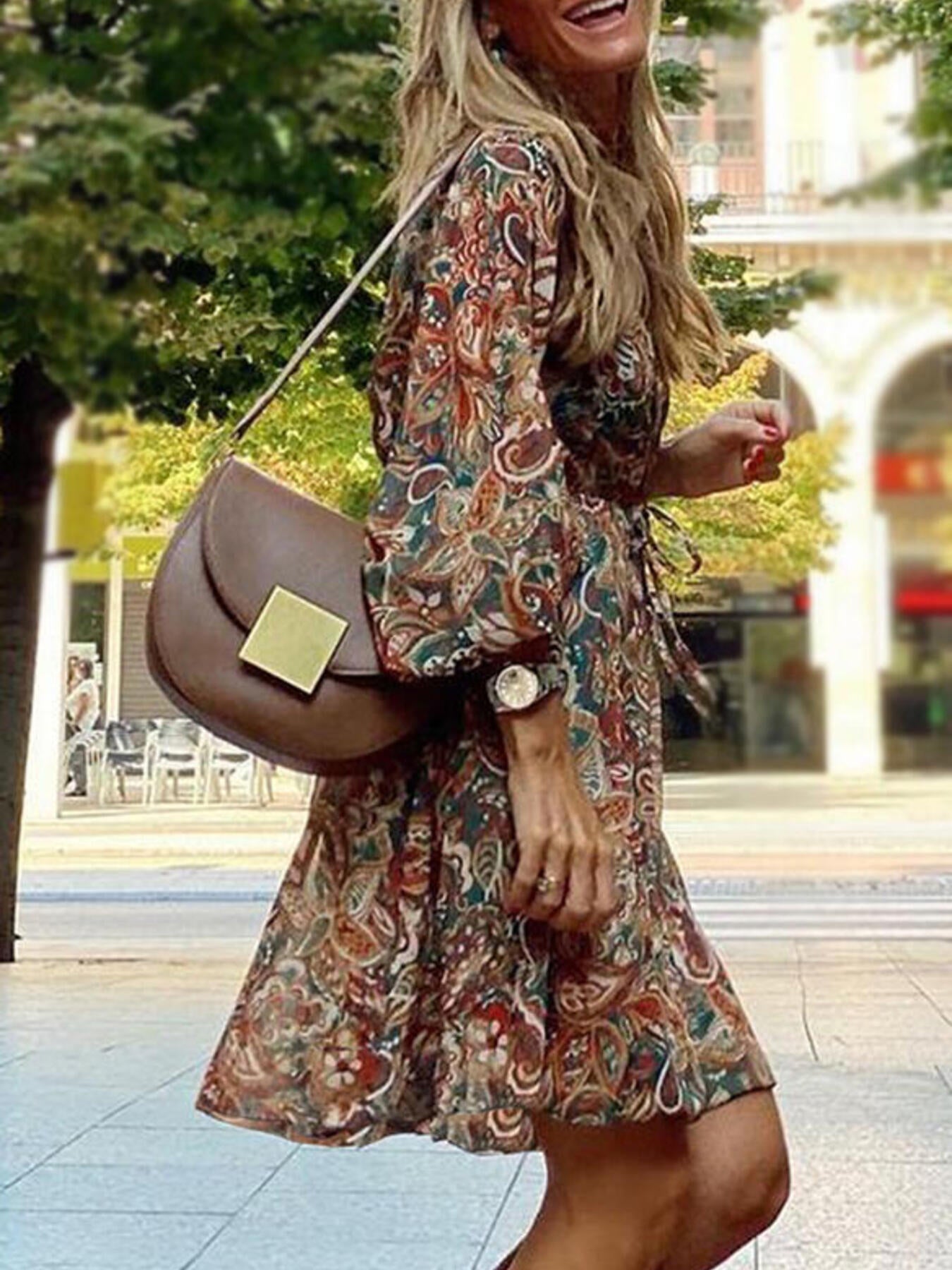 Paisley print balloon sleeve dress in brown with tie waist, worn by a woman with a brown crossbody bag.