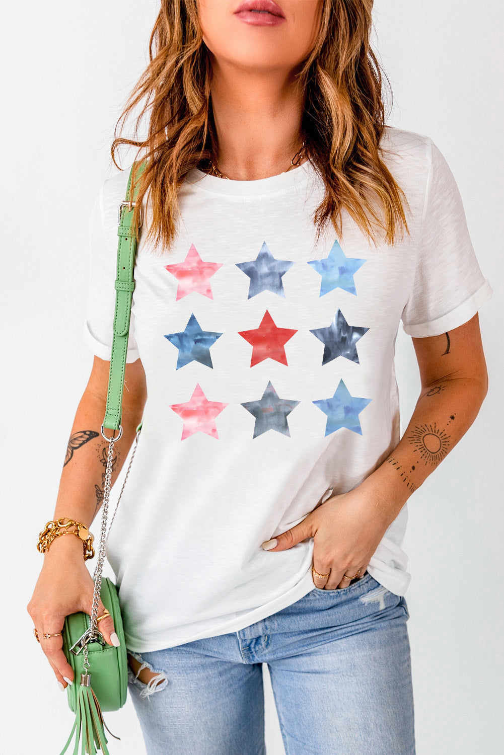White cotton crewneck tee with a watercolor starburst pattern in red, blue, and grey.