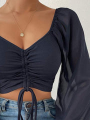 Dark Navy ruched bodice crop top with puff sleeves and tie front.
