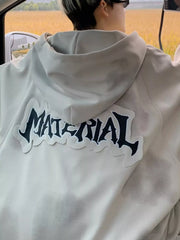 Oversized zip-up hoodie in apricot with a black graphic print on the back.