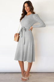 Light gray cable knit midi dress with self-tie belt and puff sleeves.