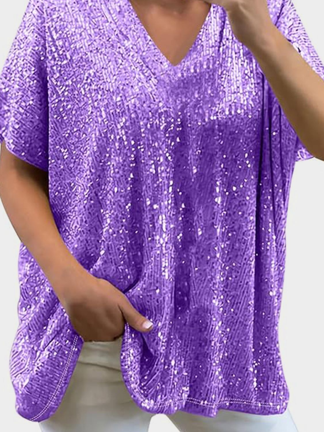 Purple sequin slouchy V-neck top with short sleeves and pockets.