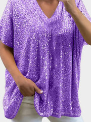 Purple sequin slouchy V-neck top with short sleeves and pockets.