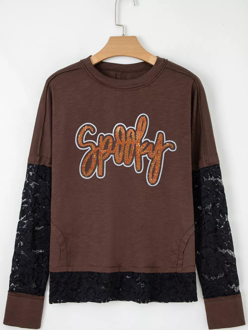 Brown cotton t-shirt with sequin spooky graphic and black lace sleeves and hem.