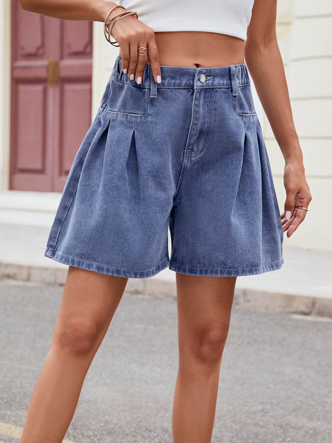 Dusty blue denim culotte shorts with front pleats and a buttoned fly.