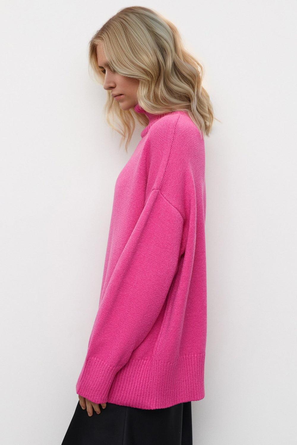 Oversized knit turtleneck sweater in vibrant hot pink with ribbed cuffs and hem.