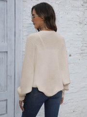 Beige batwing sleeve knit cardigan with ribbed texture and loose fit.