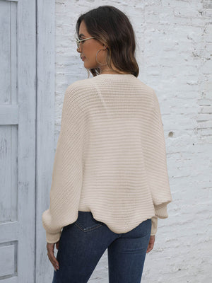 Beige batwing sleeve knit cardigan with ribbed texture and loose fit.