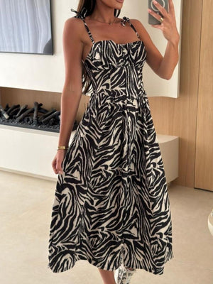 Tie-shoulder midi dress with black and white zebra print, adjustable straps, and a-line cut.